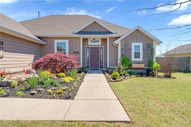4091 Ridgeton St, Springdale, AR 72764 - view of front of home featuring fence, roof with shingles, board and batten siding, and a front yard