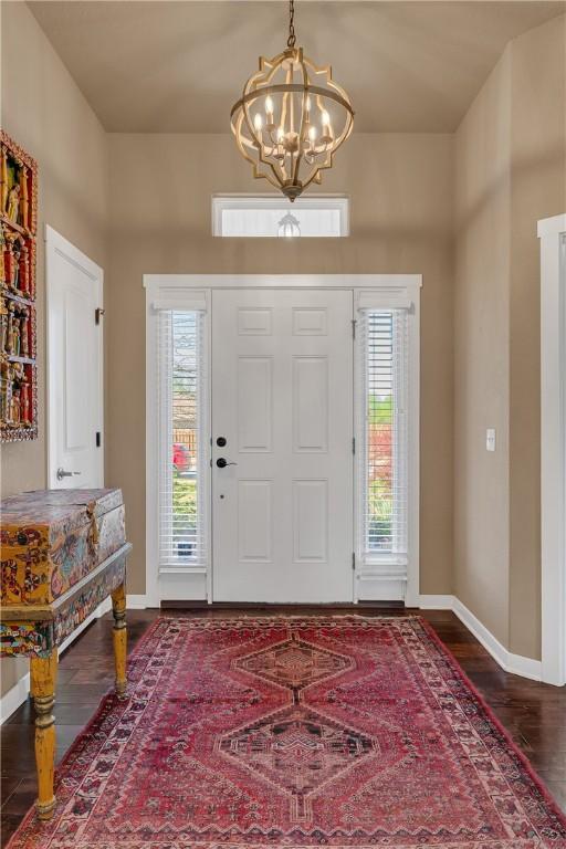 4091 Ridgeton St, Springdale, AR 72764 - foyer entrance with baseboards, wood finished floors, a wealth of natural light, and a notable chandelier