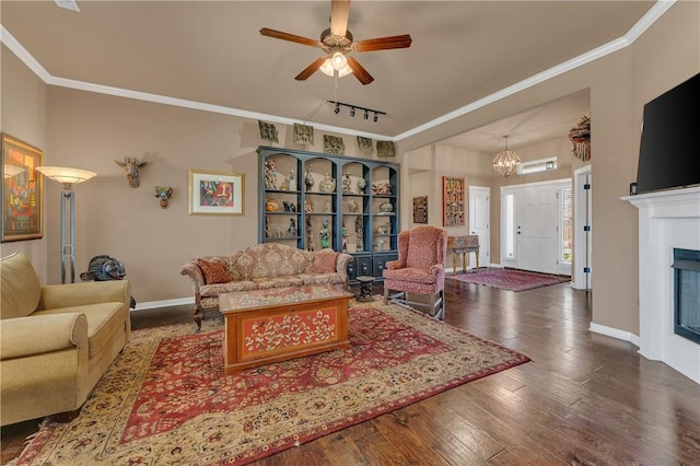 4091 Ridgeton St, Springdale, AR 72764 - living room with ceiling fan with notable chandelier, hardwood / wood-style flooring, baseboards, and crown molding
