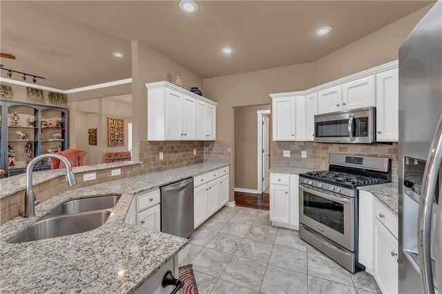 4091 Ridgeton St, Springdale, AR 72764 - kitchen featuring a sink, marble finish floor, stainless steel appliances, white cabinets, and backsplash