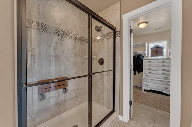 4091 Ridgeton St, Springdale, AR 72764 - bathroom featuring a walk in closet, visible vents, tile patterned flooring, and a stall shower