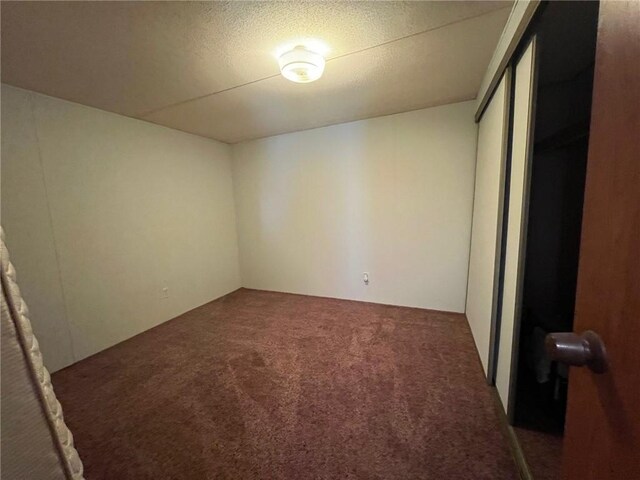 unfurnished bedroom featuring carpet floors and a closet