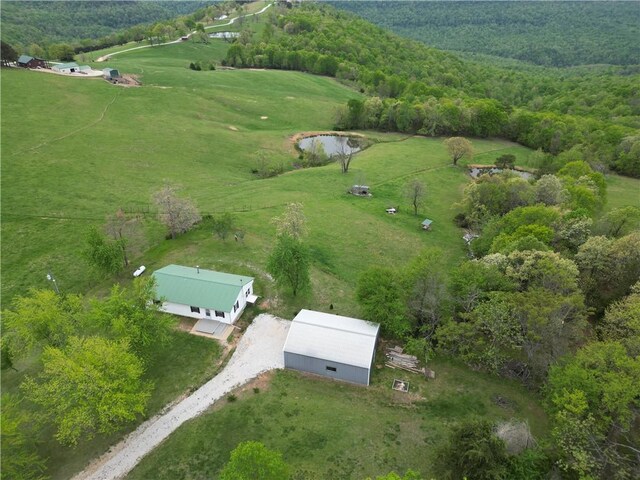 bird's eye view featuring a rural view and a wooded view