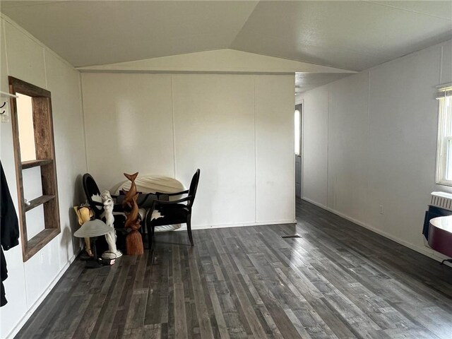 dining area with lofted ceiling, heating unit, and dark wood-style flooring