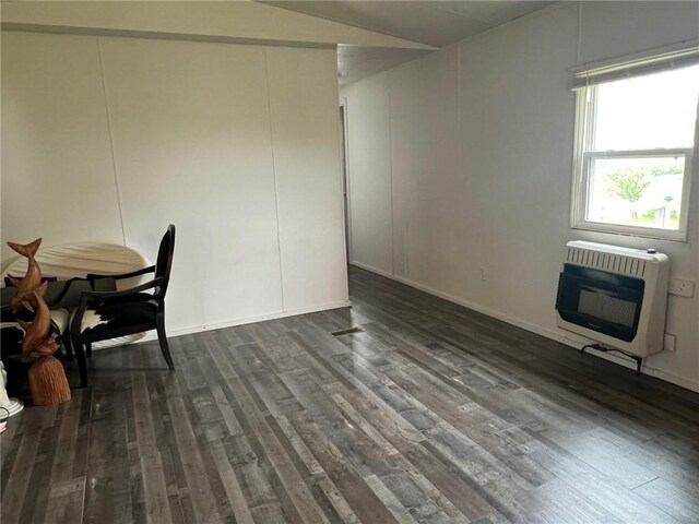 dining space with dark wood-style flooring and heating unit