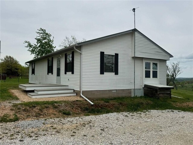 view of home's exterior with crawl space