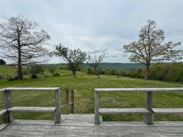 view of yard with a rural view and a deck