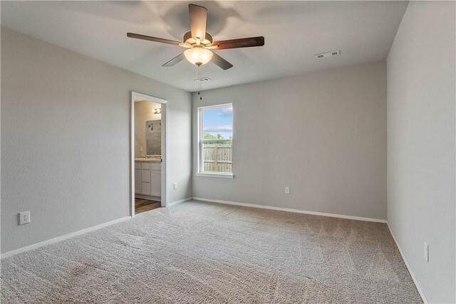 spare room featuring baseboards, visible vents, carpet, and ceiling fan