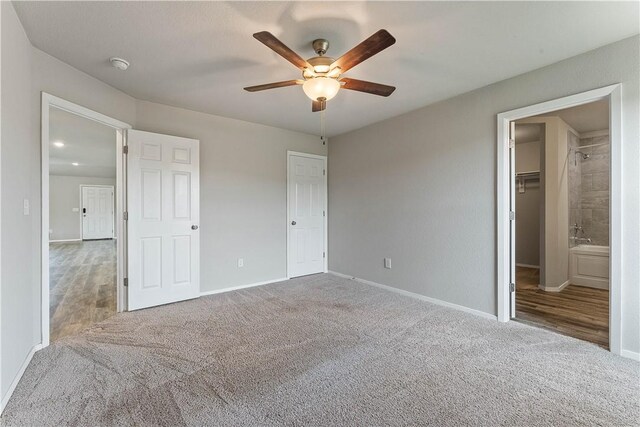 unfurnished bedroom with ceiling fan, baseboards, and carpet
