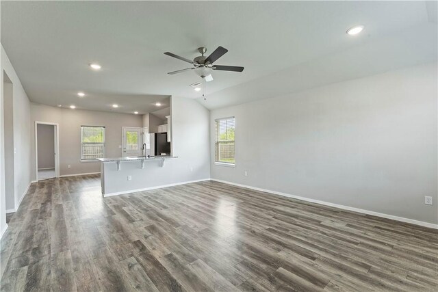 unfurnished living room with recessed lighting, a ceiling fan, baseboards, and dark wood-style flooring