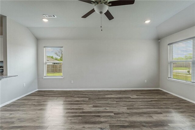 spare room with vaulted ceiling, visible vents, and a wealth of natural light