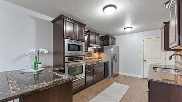 505 Blair Cir, Pea Ridge, AR 72751 - kitchen featuring dark brown cabinets, a sink, dark stone counters, stainless steel appliances, and tasteful backsplash