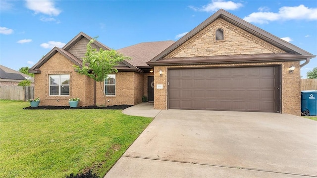 505 Blair Cir, Pea Ridge, AR 72751 - view of front of house featuring a garage, fence, a front yard, brick siding, and driveway
