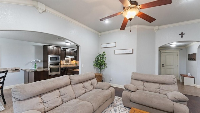 505 Blair Cir, Pea Ridge, AR 72751 - living room featuring arched walkways, ceiling fan, and ornamental molding