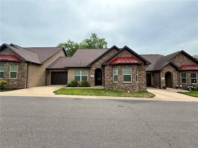 craftsman-style house featuring an attached garage, stone siding, a standing seam roof, and concrete driveway