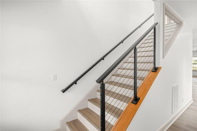 220 N C St, Rogers, AR 72756 - staircase featuring wood finished floors and baseboards