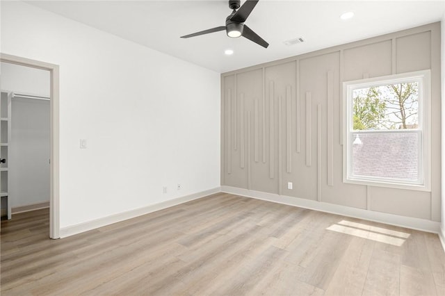 220 N C St, Rogers, AR 72756 - unfurnished bedroom with a closet, light wood-style floors, recessed lighting, a spacious closet, and ceiling fan