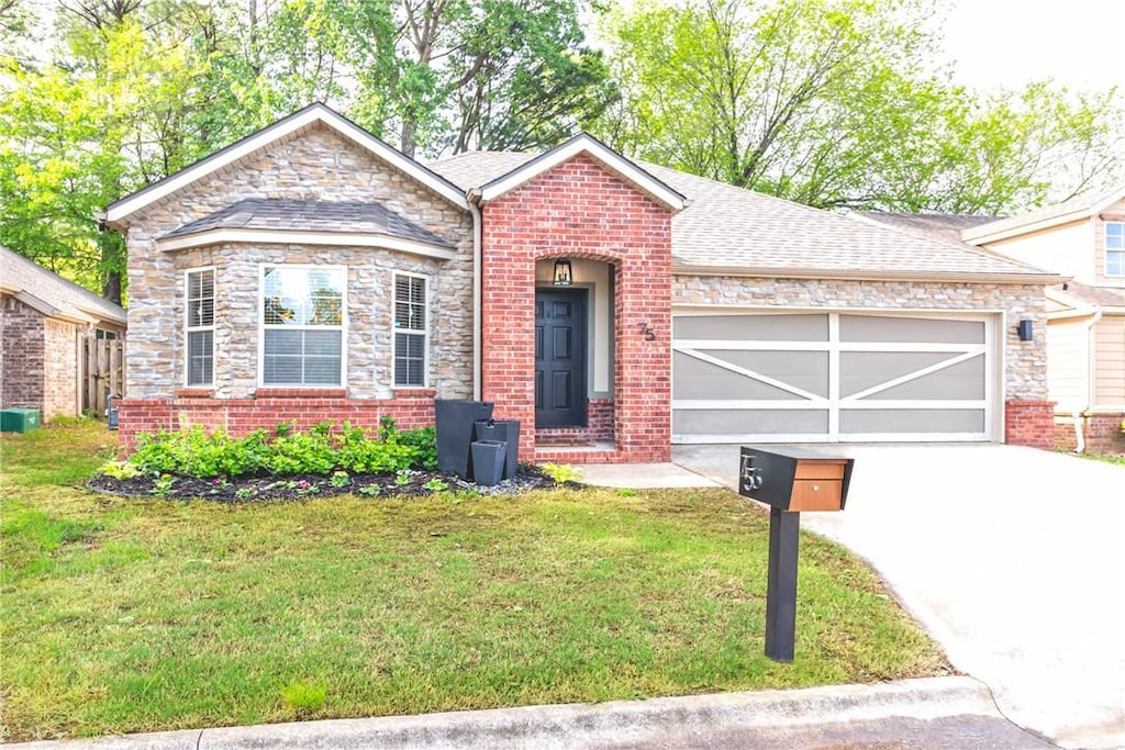 75 E Madrid St, Fayetteville, AR 72703 - ranch-style house with driveway, an attached garage, a front yard, brick siding, and roof with shingles