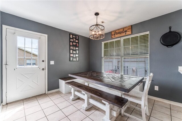 dining room with baseboards, a chandelier, and light tile patterned floors