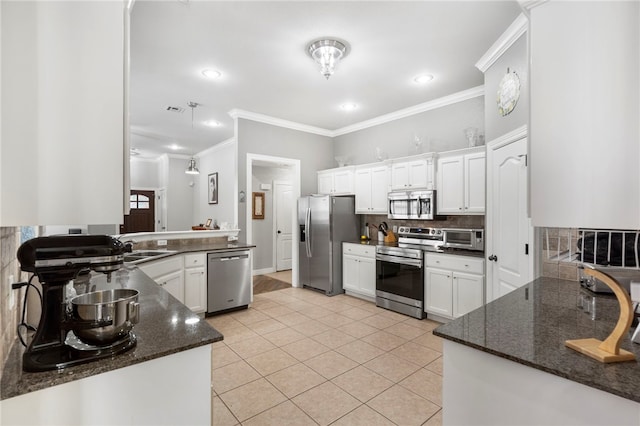 kitchen featuring stainless steel appliances, white cabinetry, backsplash, crown molding, and light tile patterned floors