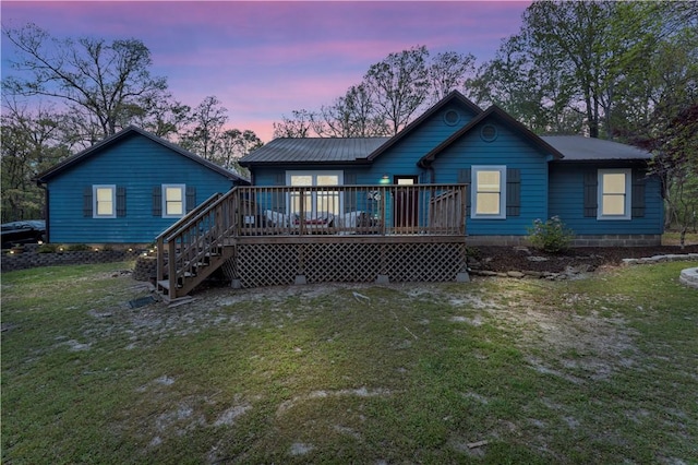 3531 Wagner Rd, Fayetteville, AR 72704 - back of property at dusk with a wooden deck, a yard, stairway, and metal roof