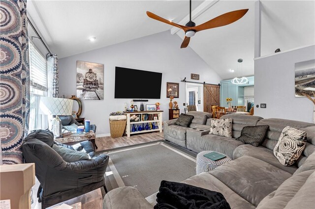 3531 Wagner Rd, Fayetteville, AR 72704 - living room featuring a barn door, ceiling fan, wood finished floors, high vaulted ceiling, and baseboards