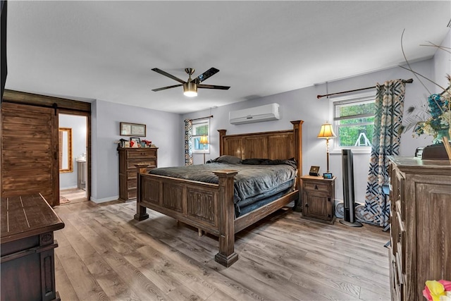 3531 Wagner Rd, Fayetteville, AR 72704 - bedroom featuring a wall unit AC, light wood finished floors, a barn door, a ceiling fan, and baseboards