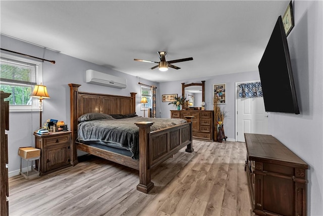 3531 Wagner Rd, Fayetteville, AR 72704 - bedroom featuring an AC wall unit, light wood-type flooring, baseboards, and a ceiling fan