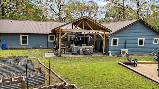 3531 Wagner Rd, Fayetteville, AR 72704 - back of house featuring a vegetable garden, a patio, a gazebo, metal roof, and a lawn