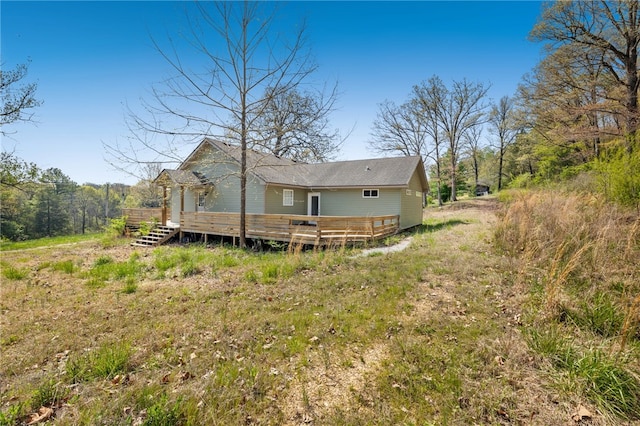 back of property featuring a wooden deck