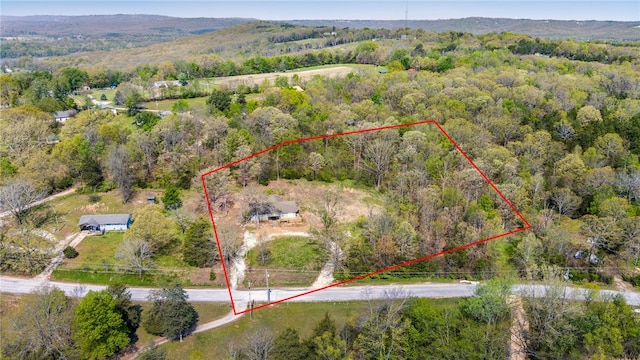birds eye view of property featuring a wooded view