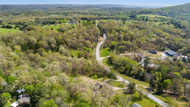drone / aerial view featuring a forest view