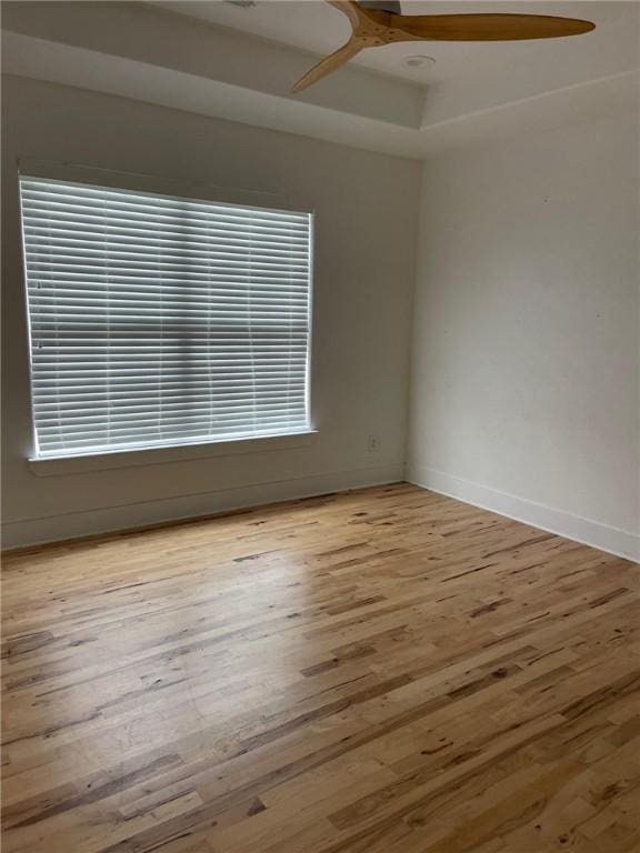 empty room with baseboards, wood finished floors, beam ceiling, and coffered ceiling
