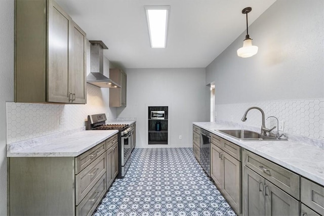 501 SE Main St, Gravette, AR 72736 - kitchen featuring wall chimney range hood, appliances with stainless steel finishes, a sink, and light countertops