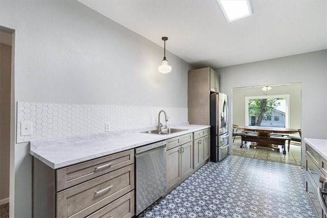 501 SE Main St, Gravette, AR 72736 - kitchen featuring light countertops, hanging light fixtures, stainless steel appliances, and a sink
