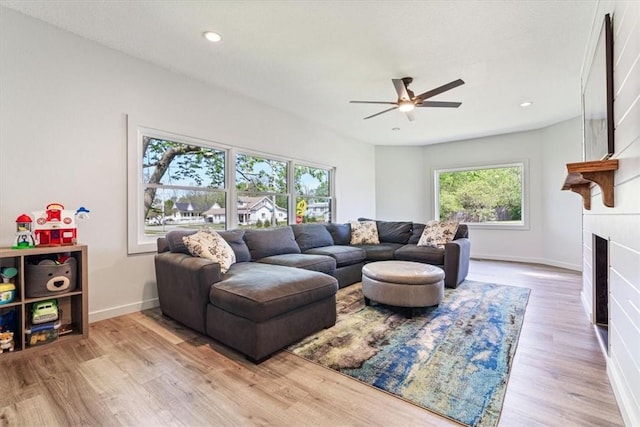 501 SE Main St, Gravette, AR 72736 - living area featuring ceiling fan, baseboards, a large fireplace, and wood finished floors