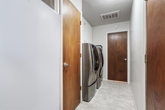 501 SE Main St, Gravette, AR 72736 - laundry room with laundry area, visible vents, independent washer and dryer, light wood-type flooring, and baseboards