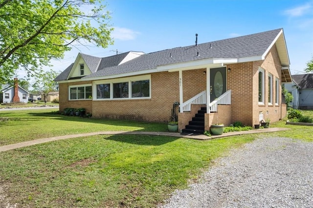 501 SE Main St, Gravette, AR 72736 - ranch-style house with brick siding, a shingled roof, and a front yard