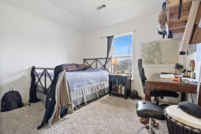 carpeted bedroom featuring visible vents and baseboards