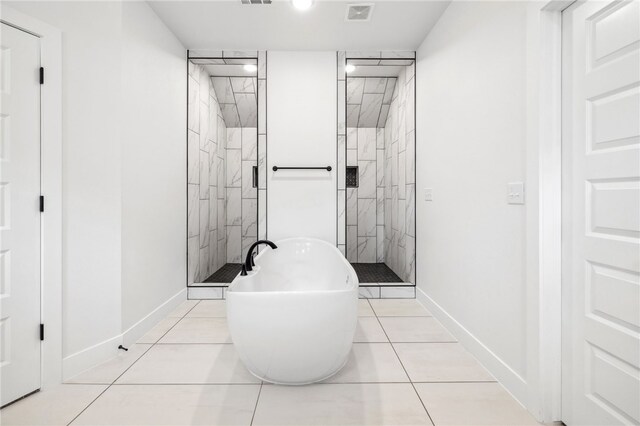 full bathroom with a soaking tub, visible vents, a shower stall, and baseboards