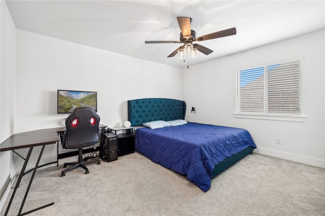 carpeted bedroom with a ceiling fan and baseboards