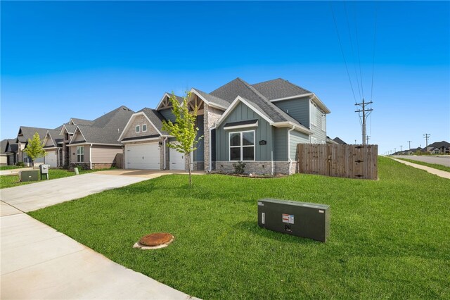 craftsman-style house with driveway, board and batten siding, stone siding, an attached garage, and fence