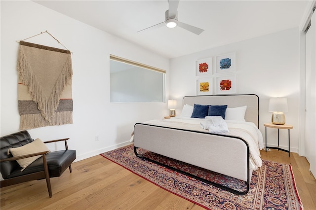 502 SE Tourmaline Mews, Bentonville, AR 72712 - bedroom featuring wood finished floors, baseboards, and a ceiling fan