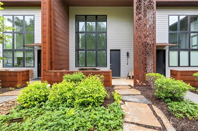 502 SE Tourmaline Mews, Bentonville, AR 72712 - doorway to property featuring covered porch