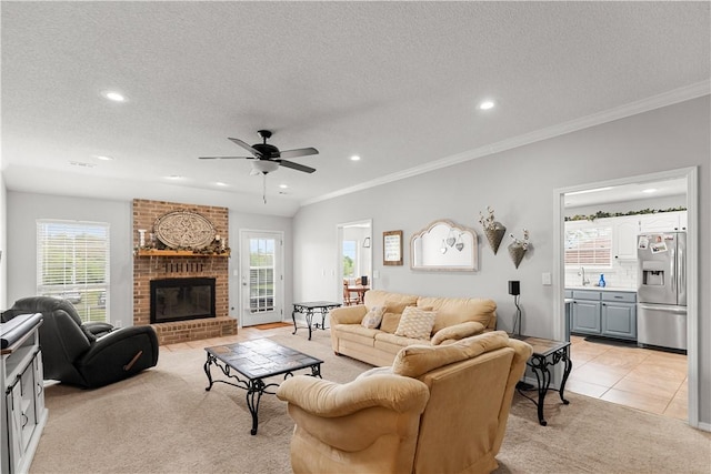 424 W Tanner Dr, Fayetteville, AR 72701 - living room with recessed lighting, light carpet, ceiling fan, a fireplace, and crown molding