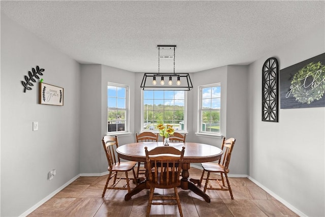 424 W Tanner Dr, Fayetteville, AR 72701 - dining space with baseboards and a textured ceiling