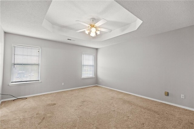 424 W Tanner Dr, Fayetteville, AR 72701 - unfurnished room featuring carpet flooring, a raised ceiling, a ceiling fan, baseboards, and a textured ceiling