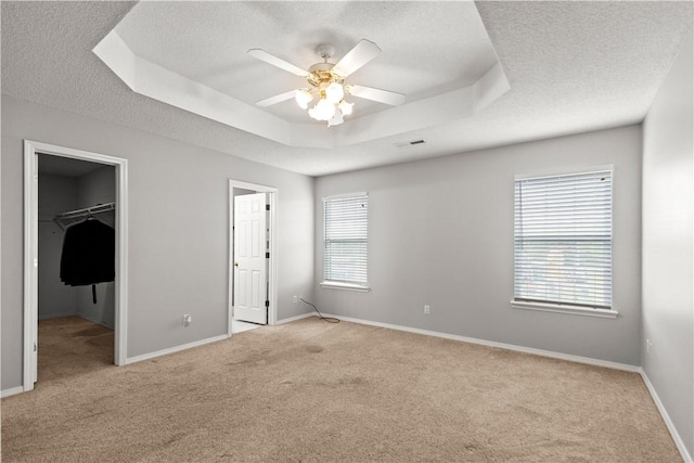 424 W Tanner Dr, Fayetteville, AR 72701 - unfurnished bedroom with light colored carpet, a tray ceiling, and a textured ceiling