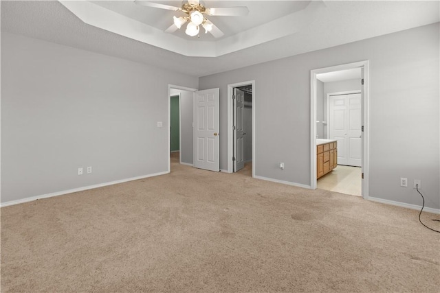 424 W Tanner Dr, Fayetteville, AR 72701 - unfurnished bedroom with baseboards, a raised ceiling, light carpet, and ensuite bathroom