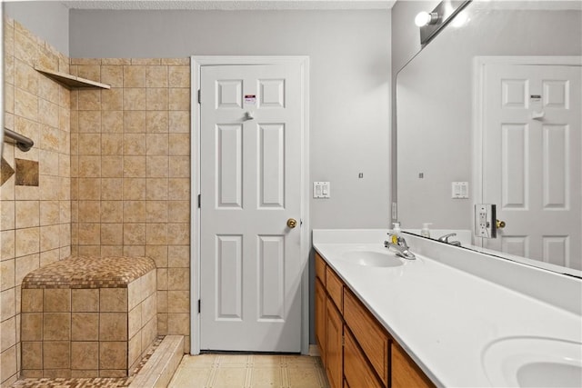 424 W Tanner Dr, Fayetteville, AR 72701 - full bathroom featuring a tile shower, tile patterned flooring, double vanity, and a sink